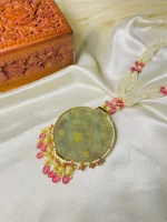 Antique stone pendant highlighted with intricate 22K gold detailing