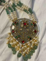 Traditional antique stone jewellery with detailed gold inlay work