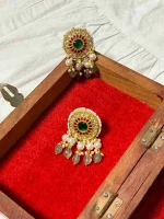 Natural diamond polki embellishments on finely crafted 22K gold earrings